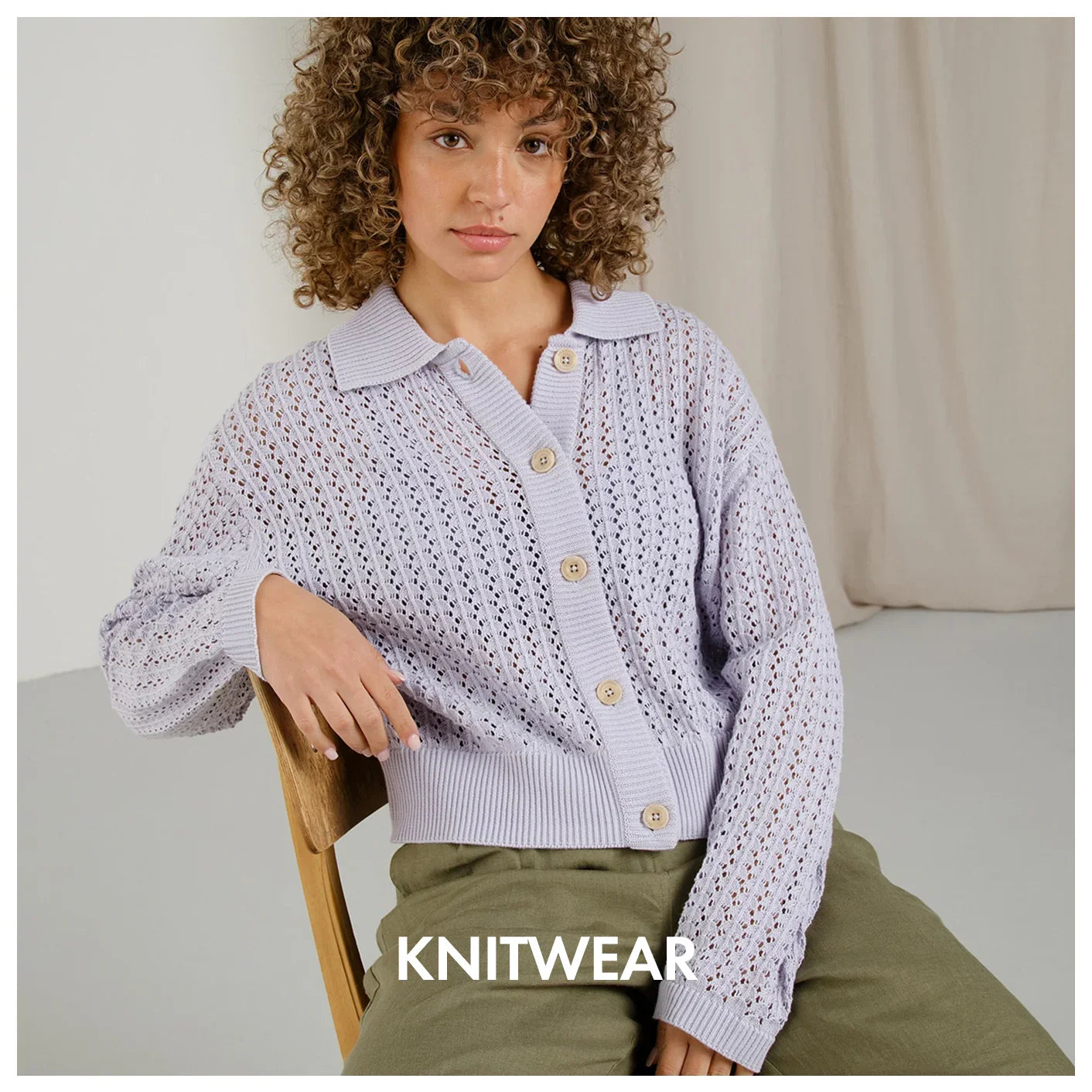 Woman in lavender knit cardigan with wooden buttons, stylish knitwear fashion