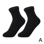 Pair of black ankle socks with soft cuff, plain design on white background