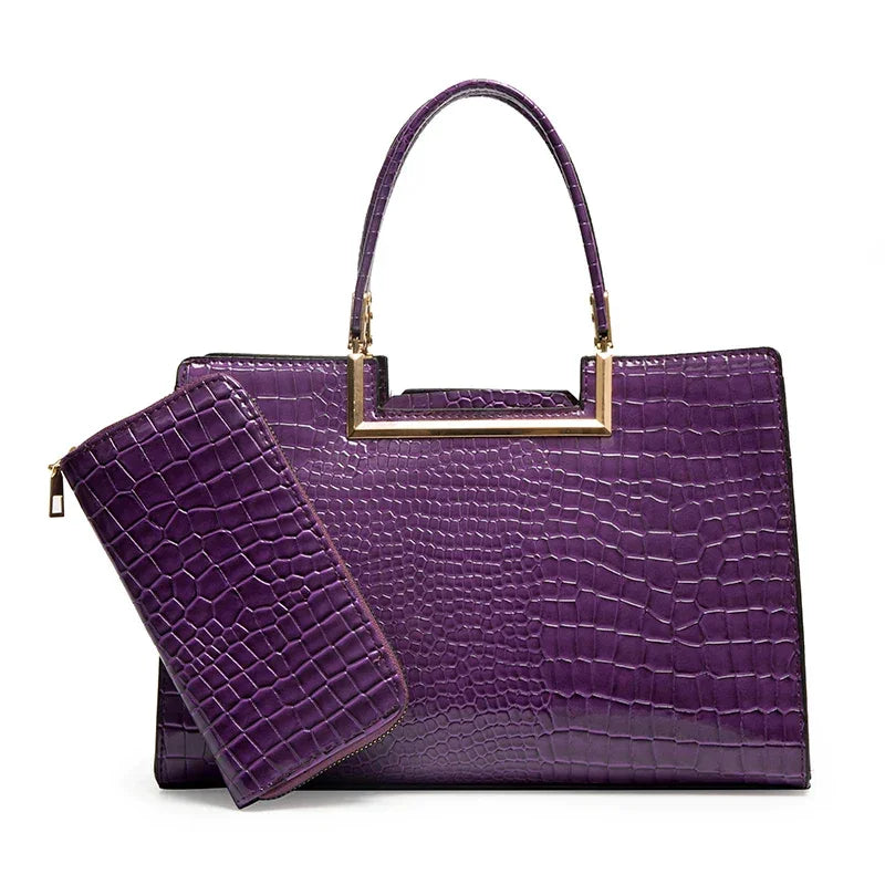 Purple crocodile-embossed handbag with matching wallet and gold handle accent