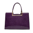 Purple crocodile-embossed handbag with gold rectangular handle, elegant accessory