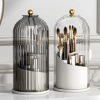 Elegant glass makeup brush organizers with gold lids on a marble vanity table