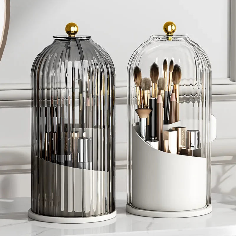 Elegant glass makeup brush organizers with gold lids on a marble vanity table