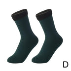 Pair of dark green ankle socks with black fleece cuffs on white background