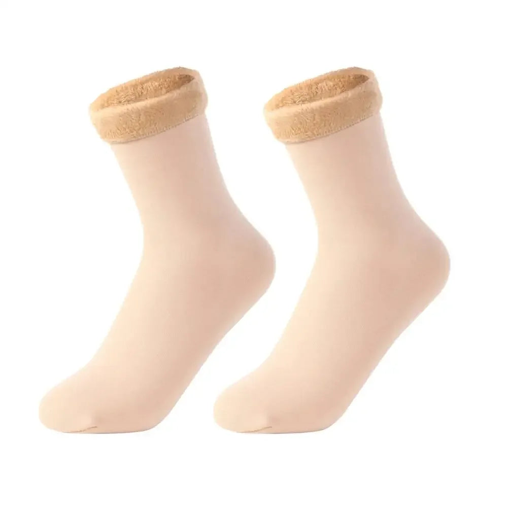 Pair of beige ankle socks with plush, fuzzy cuffs on white background