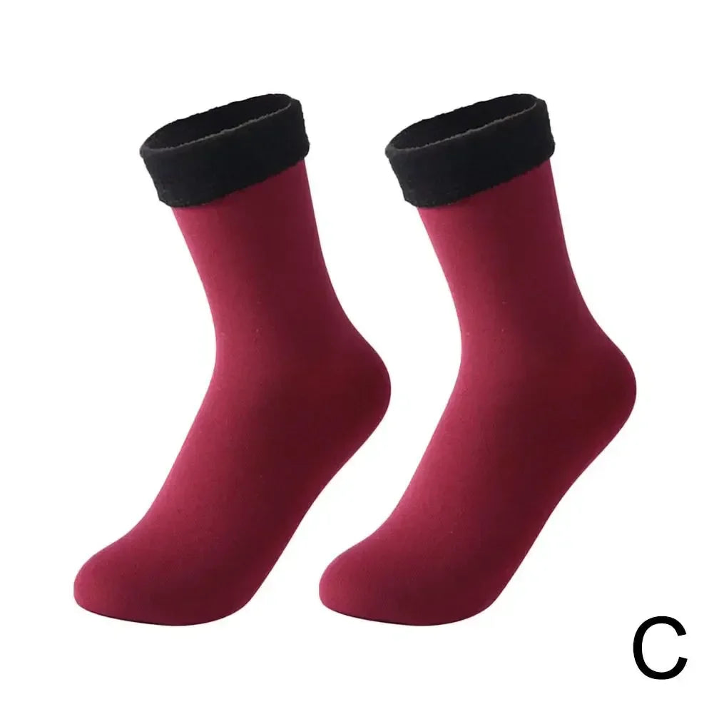 Pair of burgundy ankle socks with black cuffs on white background